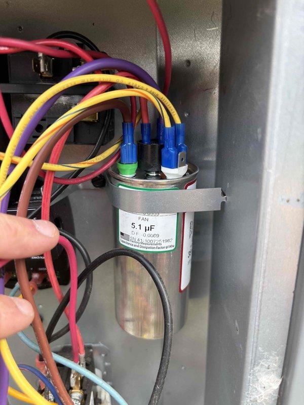 Responded to no cooling condition on downstairs HVAC system. Upon inspection, diagnosed failed run capacitor (5.1 µF) preventing compressor operation. Replaced defective capacitor, verified proper electrical connections, and tested system operation. Unit restored to normal cooling function with compressor running and proper refrigerant cycling confirmed.
