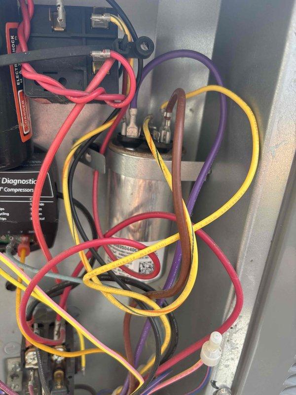 Responded to no cooling condition on downstairs HVAC system. Upon inspection, diagnosed failed run capacitor (5.1 µF) preventing compressor operation. Replaced defective capacitor, verified proper electrical connections, and tested system operation. Unit restored to normal cooling function with compressor running and proper refrigerant cycling confirmed.