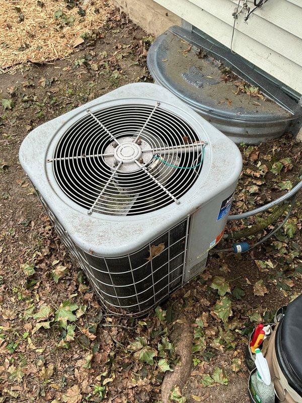 Responded to no cooling complaint on 26-year-old AMA system. Upon arrival, inspected outdoor condenser unit and found capacitor showing signs of age and deterioration with accumulated debris on mounting platform. Intermittent cooling issue reported over past 3-4 weeks consistent with failing capacitor symptoms. Documented equipment condition with photos showing capacitor, electrical connections, and overall unit condition for service records.