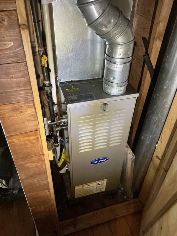 Conducted on-site assessment for whole house generator installation at residential summer cottage property. Documented existing electrical infrastructure including main breaker panel with 26-circuit capacity serving furnace, HVAC systems (new and old A/C units), kitchen appliances, water heater, upstairs sub-panel, and various room circuits. Evaluated current Carrier furnace installation in utility area with gas supply lines and ductwork configuration. Photographed electrical panel directory showing circuit distribution and existing load calculations to determine generator sizing requirements and transfer switch specifications. Provided consultation on backup power options and alternatives suitable for seasonal cottage application.