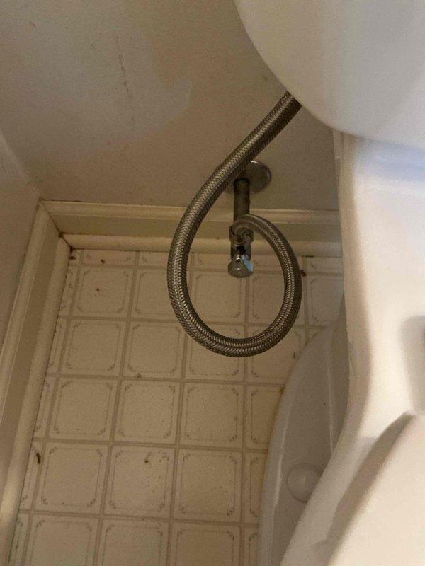 Responded to service call for toilet replacement evaluation. Upon arrival, inspected existing toilet installation and plumbing connections, including flexible braided supply line and wall-mounted shutoff valve. Documented current condition of fixtures and surrounding tile work with photographs for customer records and replacement assessment.
