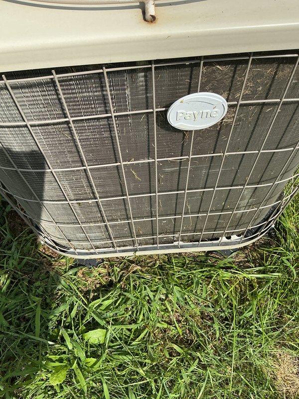 Completed annual cooling maintenance on 8-year-old Payne air conditioning system with 2021 condenser model. Performed comprehensive tune-up including inspection of outdoor unit, verified proper operation of fan assembly and motor, checked refrigerant levels and system pressures, cleaned condenser coils and protective grille which showed moderate dirt and debris accumulation from outdoor exposure, inspected electrical connections and capacitor, verified proper airflow through mesh screening, and tested overall system performance. Unit operational and ready for cooling season.