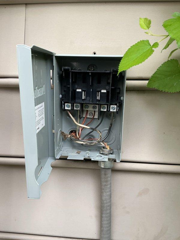 Completed annual cooling maintenance on 17-year-old Carrier air conditioning system. Performed standard inspection of electrical disconnect box, verifying proper wire connections, terminal tightness, and breaker operation; documented equipment condition with photos showing outdoor disconnect enclosure with some age-related weathering but functional components. All electrical connections secure and system operational upon completion of preventive maintenance visit.