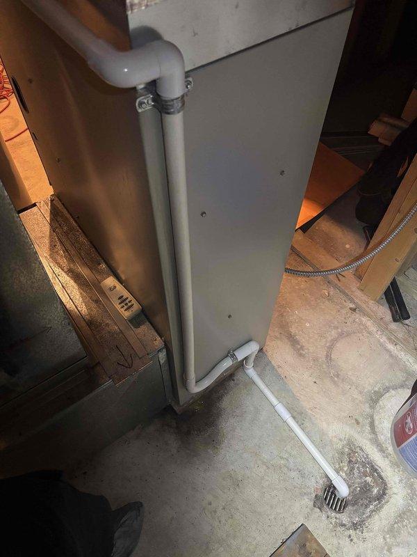 Completed annual cooling maintenance inspection on residential AC system. Performed standard tune-up procedures including filter check, refrigerant level verification, electrical connections inspection, and condensate drain system evaluation. During inspection, identified rust staining on PVC condensate drain piping near metal mounting bracket, indicating previous moisture exposure or mineral deposits. Verified drain line is flowing properly with no active leaks present. All system components operating within normal parameters at time of service.