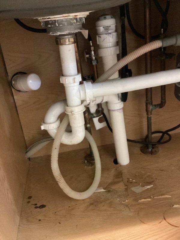 Completed quoted repair work on kitchen sink drain assembly. Accessed plumbing beneath sink basin and in adjacent crawl space to address drainage issues. Inspected P-trap configuration, PVC drain lines, and associated piping connections. Verified proper drainage flow and secured all plumbing connections to prevent future leaks.