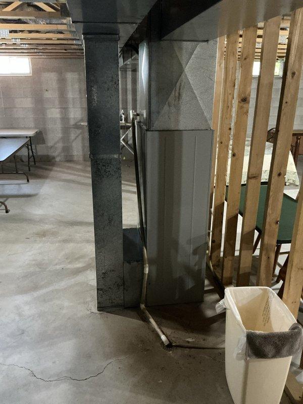 Completed on-site assessment for furnace and air conditioning system replacement estimate. Documented existing HVAC infrastructure including basement ductwork configuration and evaluated installation requirements for new heating and cooling equipment in residential property with unfinished basement utility area.