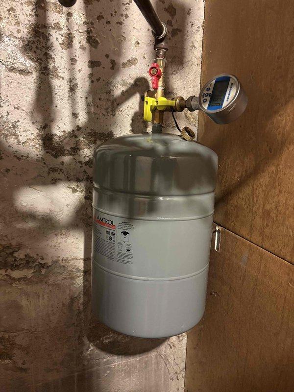 Replaced failed expansion tank and malfunctioning 30 lb pressure relief valve on hydronic heating system that had exceeded safe operating pressure, reaching 39 psi. Installed new Amtrol expansion tank with brass fittings, ball valve assembly, and digital pressure gauge to monitor system pressure and prevent future over-pressurization. System tested and verified operating within normal pressure parameters.