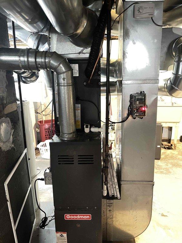 Completed full air conditioning system replacement in basement mechanical room. Installed new Goodman AC unit with corresponding air handler, integrated with existing furnace system. Connected all ductwork, electrical components, flue piping, and control systems to ensure proper operation and code compliance.