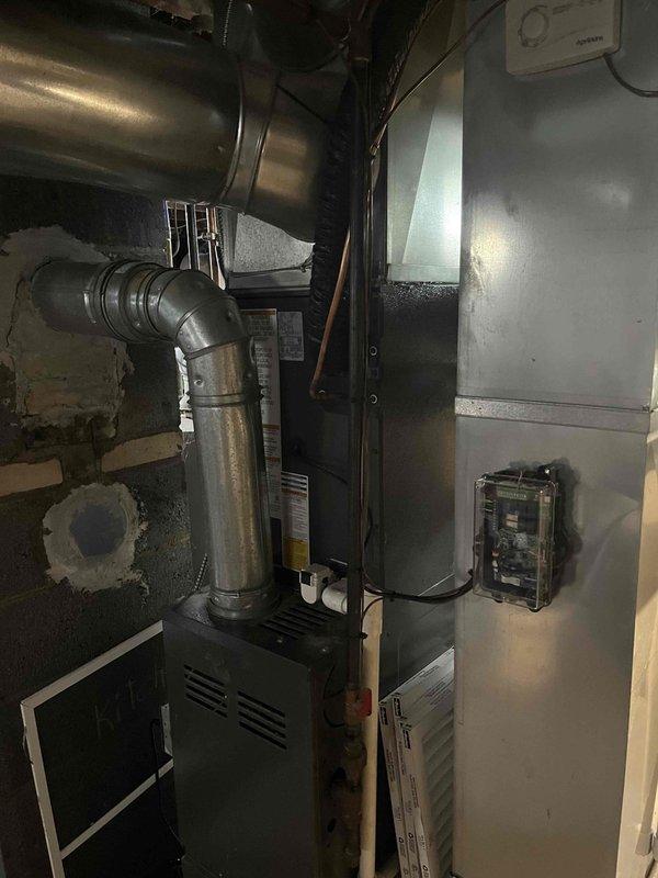 Completed full air conditioning system replacement in basement mechanical room. Installed new Goodman AC unit with corresponding air handler, integrated with existing furnace system. Connected all ductwork, electrical components, flue piping, and control systems to ensure proper operation and code compliance.