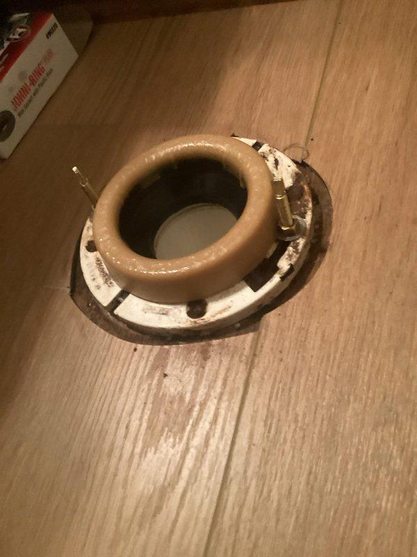 Reinstalled toilet in residential bathroom after replacing deteriorated wax ring seal. Removed existing toilet, inspected corroded flange assembly with rusted mounting hardware, installed new wax ring, and secured toilet back to floor with proper sealing. Verified water supply connections and tested for leaks to ensure proper operation.