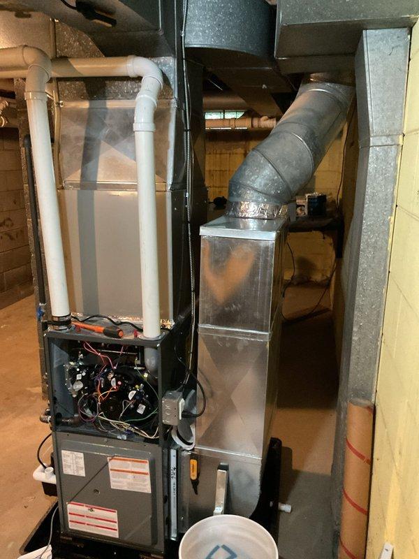 Responded to no cooling call on two-year-old Carrier system with complete loss of heating and cooling operation. Accessed furnace control board and electrical components to diagnose issue. Inspected air handler unit, condensate drain system, and ductwork connections. Documented equipment condition and internal wiring configuration for service records.