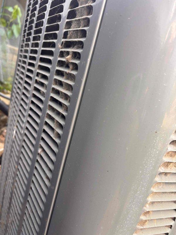 Responded to no cooling complaint at residential property. Upon arrival, performed system diagnostics on air conditioning unit. Inspected outdoor condenser unit and found moderate accumulation of dust and debris on intake grille, restricting proper airflow. Examined indoor components including supply water lines and electrical control panel. Verified all electrical connections, circuit protection devices, and control wiring were properly secured and functioning. Cleaned condenser coil and grille surfaces to restore adequate airflow through heat exchanger. Tested system operation and confirmed unit now cooling to setpoint temperature. System restored to normal operating condition.