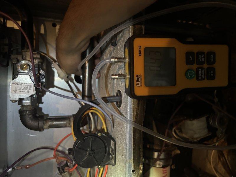 Responded to water leak complaint with condensation dripping into drop ceiling below air handler unit. Inspected evaporator coil assembly, drain pan, and condensate drain line for blockages or overflow conditions. Verified unit cooling operation normal with no refrigerant issues. Documented equipment condition and condensate management system with photos. Cleared condensate drain line obstruction and confirmed proper drainage to prevent further leakage into ceiling space.