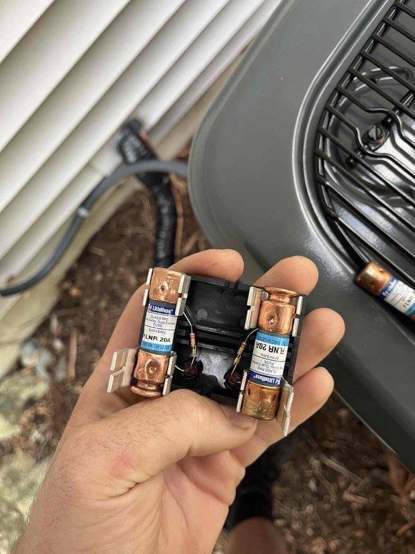 Responded to mechanical inspector's correction notice regarding oversized fuses on recently installed air conditioning condenser unit. Inspector identified 30-amp fuses installed in disconnect box, which exceeded the manufacturer's maximum overcurrent protection rating of 20 amps specified on the condenser nameplate. Documented existing installation with detailed photographs showing the oversized FLNR 30A Littelfuse fuses and condenser unit for inspector review and approval consideration per inspector's request.