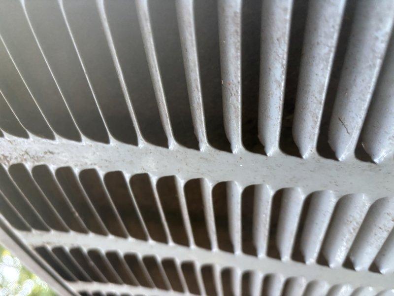 Completed annual cooling system maintenance and inspection as part of 2-year EnergiAir warranty program. Performed comprehensive AC tune-up including visual inspection of outdoor condenser unit, verified proper fin alignment and spacing on heat exchanger coils, and assessed overall system cleanliness. Condenser coils showed minor dust accumulation and slight debris presence but remained in functional condition with no significant blockages affecting airflow. All components inspected and documented with photos showing satisfactory operational status for continued seasonal use.
