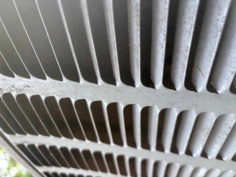 Completed annual cooling system maintenance and inspection as part of 2-year EnergiAir warranty program. Performed comprehensive AC tune-up including visual inspection of outdoor condenser unit, verified proper fin alignment and spacing on heat exchanger coils, and assessed overall system cleanliness. Condenser coils showed minor dust accumulation and slight debris presence but remained in functional condition with no significant blockages affecting airflow. All components inspected and documented with photos showing satisfactory operational status for continued seasonal use.