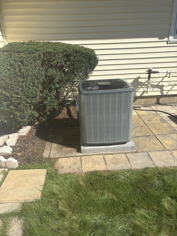 Successfully completed full air conditioning system installation at residential property. Installed new outdoor condenser unit on concrete pad against exterior wall with proper copper line set connections to indoor air handler. Unit positioned adjacent to existing landscaping with adequate clearance for airflow and future maintenance access. Verified all refrigerant lines properly insulated and secured to structure, confirmed electrical connections meet code requirements, and tested system operation for proper cooling performance. Installation completed as same-day booking with financing secured.