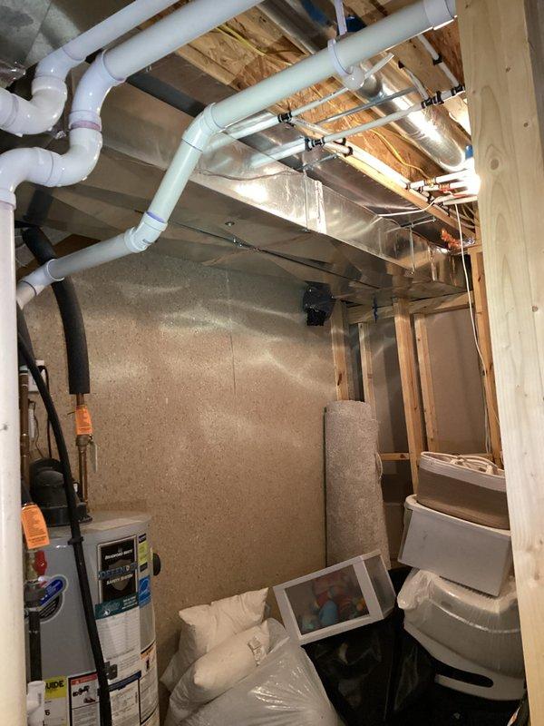 Conducted site assessment for installation of new exterior spigot in garage of single-family residence constructed in 2020. Evaluated existing plumbing infrastructure in unfinished basement, including water heater location, PVC supply lines, and copper piping routing through ceiling joists. Documented mechanical room layout and determined optimal connection point for new hose bib installation. Photographed current plumbing configuration to develop comprehensive project estimate for garage spigot addition.