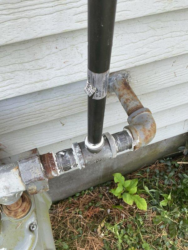 Installed new gas line from existing meter to interior of residence for fireplace application. Ran black iron pipe vertically from meter connection point up exterior wall, then horizontally along siding into house structure, terminating with stubbed connection ready for fireplace installation. Secured piping to exterior wall using appropriate mounting brackets and verified all connections for proper fitment and code compliance.