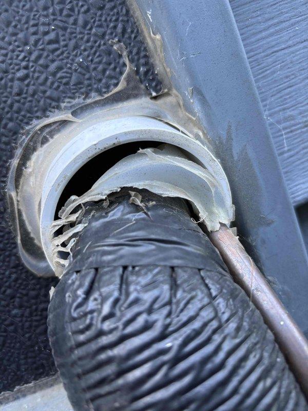Completed annual cooling maintenance on Amana AC unit under 3-year EnergiAir warranty agreement. Performed standard tune-up procedures including system inspection, cleaning, and operational testing. Documented significant deterioration of ductwork sealing at flexible duct connection point, with metallic foil tape severely degraded, torn, and peeling away from metal collar assembly, creating gaps that compromise system efficiency. Outdoor condenser unit found in good operating condition with clean exterior surfaces and proper clearance from building. Photographed compromised duct seal connection for customer records and future repair consideration.