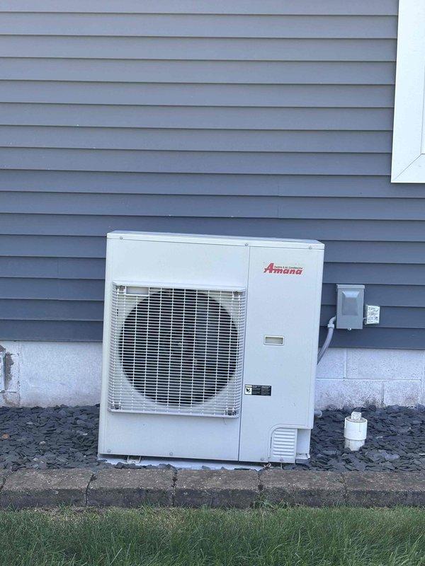 Completed annual cooling maintenance on Amana AC unit under 3-year EnergiAir warranty agreement. Performed standard tune-up procedures including system inspection, cleaning, and operational testing. Documented significant deterioration of ductwork sealing at flexible duct connection point, with metallic foil tape severely degraded, torn, and peeling away from metal collar assembly, creating gaps that compromise system efficiency. Outdoor condenser unit found in good operating condition with clean exterior surfaces and proper clearance from building. Photographed compromised duct seal connection for customer records and future repair consideration.