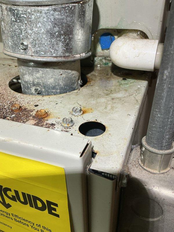 Responded to water leak complaint originating from furnace area. Upon inspection, identified failed condensate pump as source of water leakage. Unit showed significant age-related deterioration with visible corrosion on mounting hardware and platform surfaces. Documented existing conditions including rust staining around fasteners and moisture damage to equipment base. Provided customer with assessment and recommendations for condensate pump replacement to resolve active water leak issue.