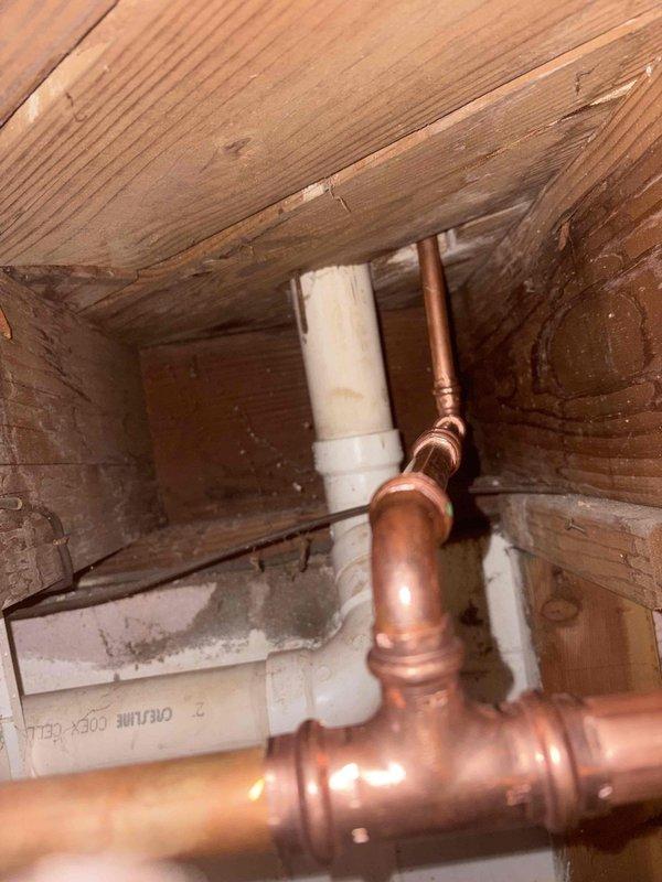 Completed comprehensive plumbing installation project including new water heater replacement, dual basket strainer installations, kitchen faucet replacement, and cable clearing of three separate drain lines servicing the bathtub, vanity, and bathroom sink, as well as kitchen sink drain. All copper supply lines were properly fitted with brass compression fittings and routed through floor joists in accordance with code requirements. PVC drainage systems were installed with proper venting and secured within the structural framing. Work was performed in confined crawl space and basement utility areas with all connections tested for proper operation and leak-free performance.