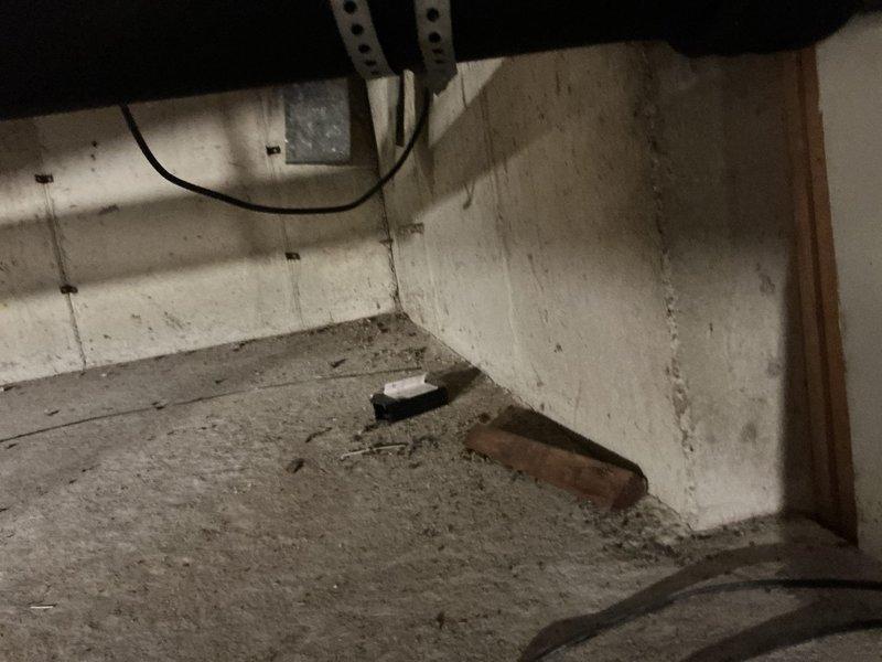 Conducted on-site assessment for mini split system installation. Evaluated basement/crawl space area with exposed concrete block walls and unfinished ceiling space, noting existing infrastructure and available mounting locations. Assessed upstairs living space with computer equipment to determine optimal indoor unit placement and electrical requirements. Documented existing conditions including structural elements, available wall space, and potential routing pathways for refrigerant lines and condensate drainage between levels.