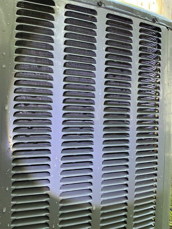 Responded to service call for outdoor HVAC unit maintenance. Upon arrival, assessed accessibility to outdoor condenser unit for routine cleaning. Determined that outdoor unit location prevented technician from reaching equipment with available water hose for standard coil cleaning procedure. Documented current condition of ventilation grilles showing accumulated dirt, dust, and discoloration on louver panels consistent with normal operational wear. Observed moisture present on vent covers and surrounding surfaces. Coordinated with customer who confirmed availability of longer hose on property to facilitate future cleaning access. Provided instruction for customer to connect extended hose for technician use during return visit to complete condenser coil cleaning. Photographed ventilation components showing current condition of metal louver panels with visible buildup requiring attention. No equipment modifications or repairs performed during this visit due to access limitations.