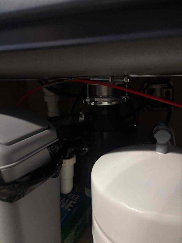 Completed kitchen remodel installation including undermount sink and pull-down faucet with brushed stainless finish in granite countertop. Verified all plumbing connections, drain assembly, and under-cabinet mechanical components are properly secured and functioning. Kitchen installation finalized and ready for use.