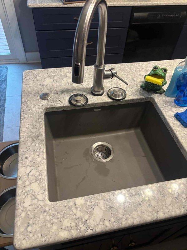 Completed kitchen remodel installation including undermount sink and pull-down faucet with brushed stainless finish in granite countertop. Verified all plumbing connections, drain assembly, and under-cabinet mechanical components are properly secured and functioning. Kitchen installation finalized and ready for use.
