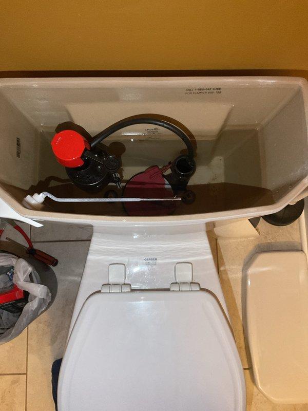 Responded to existing customer request for toilet plumbing service. Upon arrival, removed tank lid and inspected internal flush mechanism components including flapper valve, fill valve assembly, float mechanism, and connecting chains. Documented tank interior condition with photos showing all working components for service records.