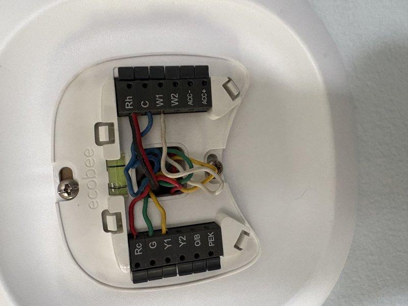 # CP-Cooling Problem

Return visit to diagnose system running constantly when thermostat in off position with fan set to auto mode. Inspected EnergiAir WT 08-2031 unit wiring and control circuits. Examined transformer/relay assembly and verified proper terminal connections at equipment. Checked ecobee thermostat wiring configuration including R, C, W1, W2, G, Y1, Y2, and OB terminals to ensure correct connections and eliminate potential wiring faults causing continuous operation. Documented equipment condition and wiring setup with photographs for diagnostic reference and future service needs.