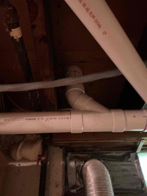 Completed partial drain repipe and cast iron waste pipe replacement in basement utility area. Installed new PVC drainage piping system with proper fittings and elbow joints to replace deteriorated sections. Routed new drain lines through existing joist spaces, ensuring proper slope and support for optimal drainage flow.