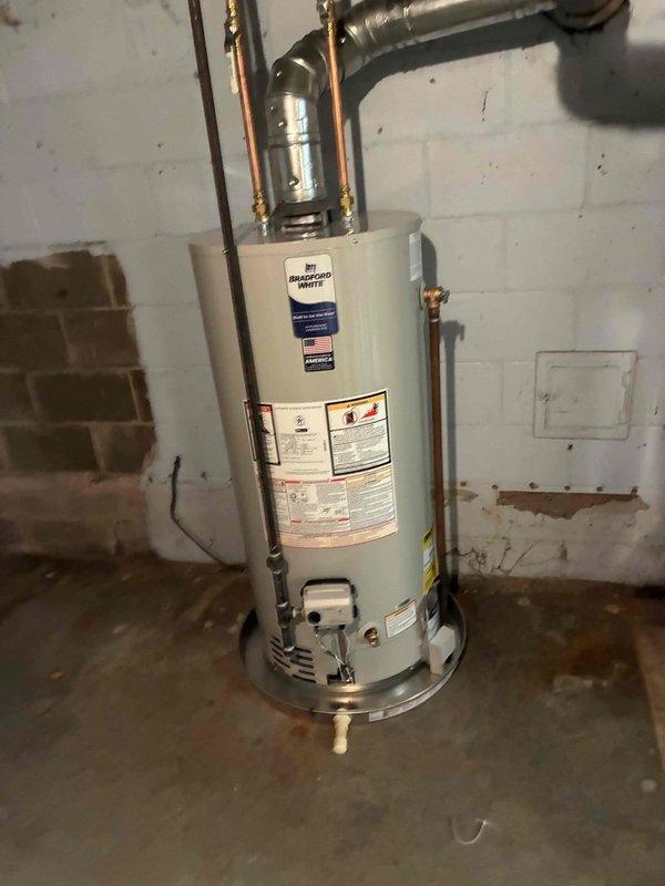 Completed inspector correction on recently installed Bradford White water heater by returning to site to properly cap the drain pan as required. The water heater installation from the previous day was brought into full code compliance per inspection requirements, ensuring proper drain pan configuration and safety standards are met.