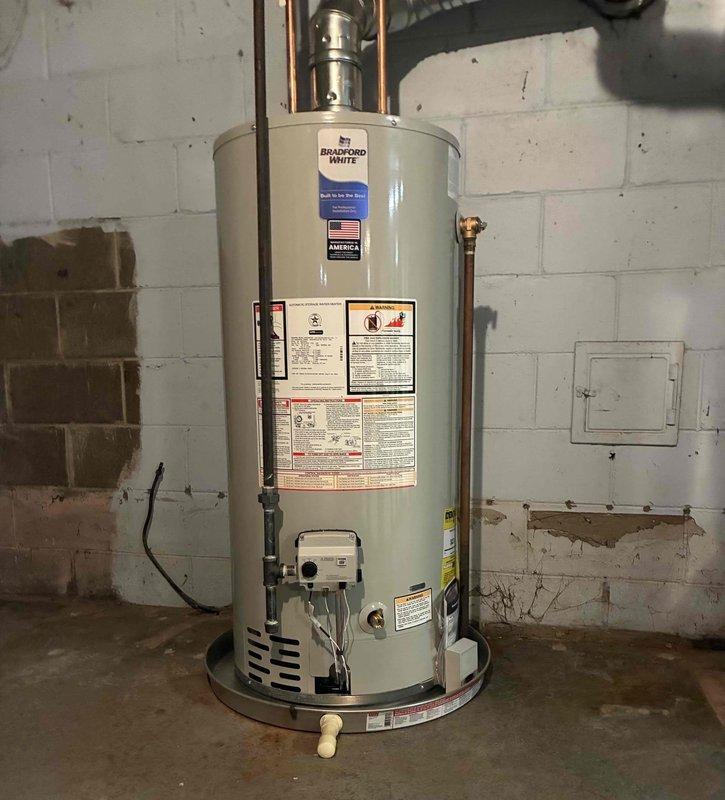 Completed inspector correction on recently installed Bradford White water heater by returning to site to properly cap the drain pan as required. The water heater installation from the previous day was brought into full code compliance per inspection requirements, ensuring proper drain pan configuration and safety standards are met.