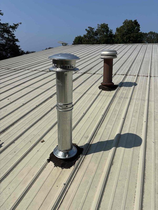 Responded to inspector correction for improper venting installation. Removed insulation from single wall pipe that was incorrectly installed through roof penetration. Installed proper B-vent piping system through roof with appropriate flashing and weatherproofing. Ensured all venting components meet code requirements for safe exhaust of combustion gases. Verified proper clearances and secure mounting of vent termination with weather cap. System now complies with inspection standards.
