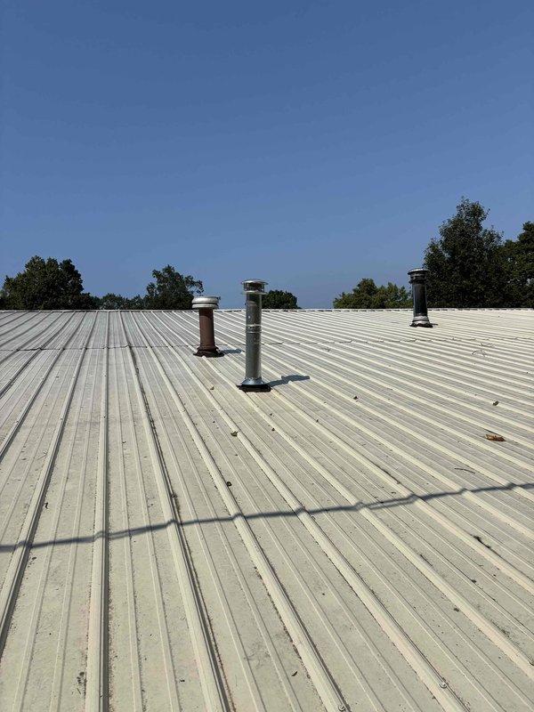 Responded to inspector correction for improper venting installation. Removed insulation from single wall pipe that was incorrectly installed through roof penetration. Installed proper B-vent piping system through roof with appropriate flashing and weatherproofing. Ensured all venting components meet code requirements for safe exhaust of combustion gases. Verified proper clearances and secure mounting of vent termination with weather cap. System now complies with inspection standards.