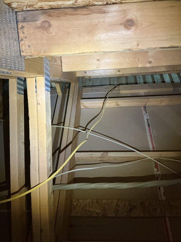 Conducted on-site assessment for new central HVAC system installation at single family residence with 550 square foot bonus room above garage requiring climate control. Evaluated unfinished bonus room space with exposed framing, OSB sheathing, and particle board flooring to determine equipment sizing requirements and installation logistics. Inspected attic access area noting existing electrical wiring, insulation, and available space for ductwork routing to serve the additional square footage. Documented current construction conditions including exposed structural members and utility pathways to develop comprehensive equipment specifications and installation plan for properly sized heating and cooling system.