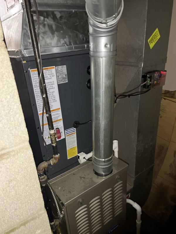 Completed full HVAC system replacement including outdoor condensing unit and indoor air handler/furnace components. Installed new outdoor condenser on existing concrete pad with proper refrigerant line connections and electrical conduit run through exterior wall. Mounted new indoor equipment in basement utility area with vertical ductwork connections and proper ventilation configuration. All units positioned per manufacturer specifications with required clearances, warning labels properly affixed, and electrical connections completed to code. System tested and verified operational upon completion.