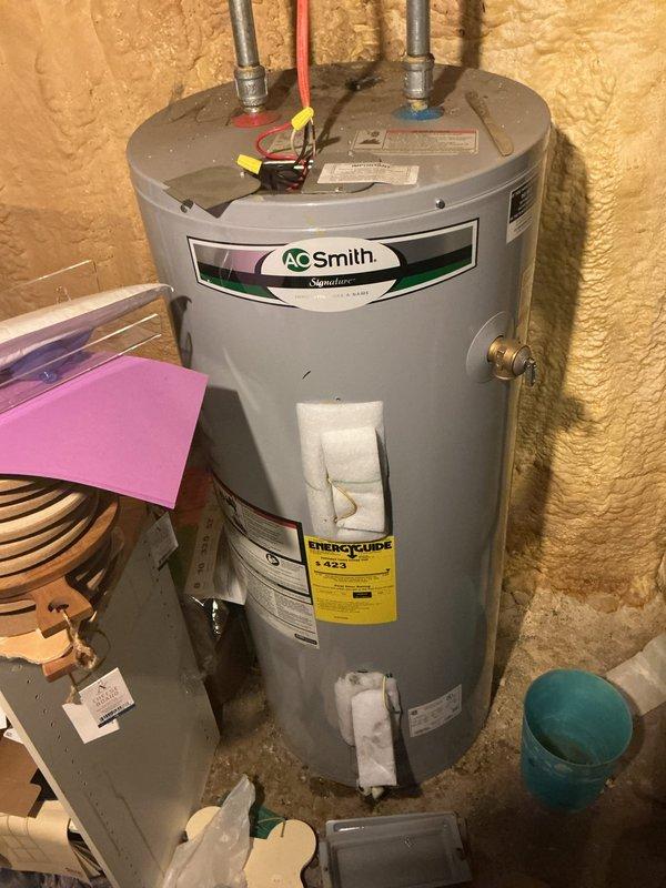 Responded to service call for AO Smith electric water heater not producing hot water. Upon inspection, discovered severe corrosion and rust damage to electrical connections at the upper terminal block. The deterioration was extensive, with heavy oxidation compromising wire connections and creating potential safety hazards. Documented conditions with photographs showing corroded terminals, rust staining, and moisture damage to electrical components. Advised customer of findings and recommended water heater replacement due to the severity of electrical system failure and associated safety concerns.