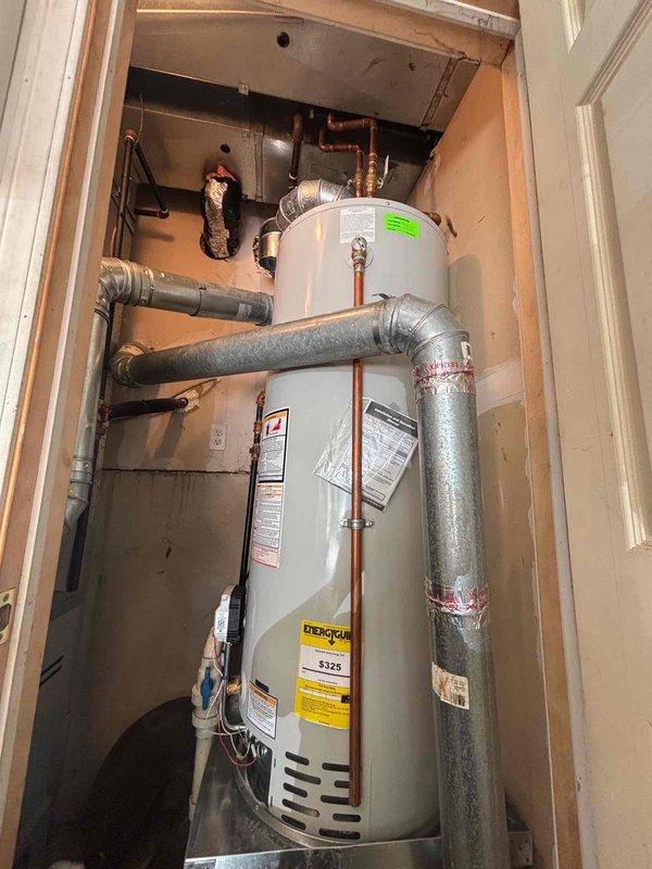 Responded to service call for Bradford White water heater that was flooded following bathroom tub replacement. Performed thorough inspection of unit and all plumbing connections after homeowner had removed standing water from area. Upon examination, verified water heater operation, checked for internal damage, inspected venting system, and tested all safety controls to ensure unit was functioning properly and safe for continued use.