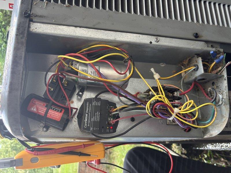 Completed annual cooling system maintenance and inspection on residential HVAC unit. Opened and inspected electrical compartment, examining all control components including capacitor, contactors, relays, and wiring connections. Performed electrical diagnostic testing using digital multimeter to verify proper voltage and system operation. Checked all wire connections for tightness and integrity across multiple circuits. Inspected heat sink assembly and overall condition of electrical controls. Documented system condition through photography for service records. Unit operating within normal parameters upon completion of tune-up service.