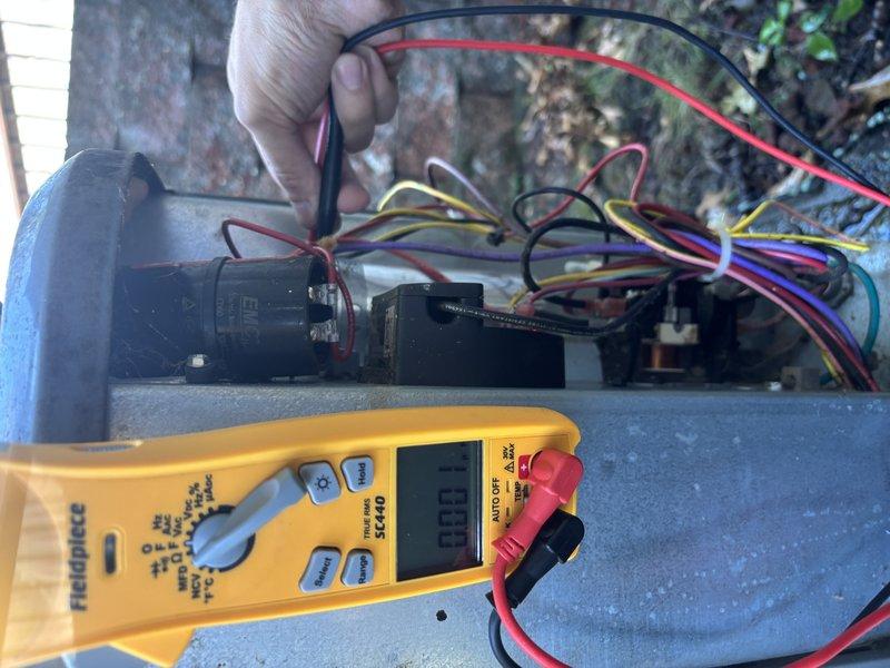 Completed annual cooling system maintenance and inspection on residential HVAC unit. Opened and inspected electrical compartment, examining all control components including capacitor, contactors, relays, and wiring connections. Performed electrical diagnostic testing using digital multimeter to verify proper voltage and system operation. Checked all wire connections for tightness and integrity across multiple circuits. Inspected heat sink assembly and overall condition of electrical controls. Documented system condition through photography for service records. Unit operating within normal parameters upon completion of tune-up service.
