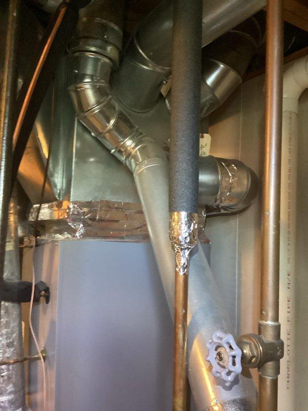Provided estimate for water heater replacement after identifying active leak at base of existing unit, with visible water staining on concrete floor around equipment. Assessed current setup including connections to HVAC system, documented existing plumbing configuration with copper supply lines and PVC venting, and discussed options for new unit installation including extended warranty coverage.