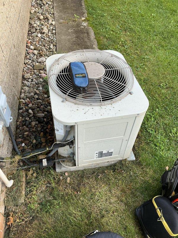 Completed annual cooling system tune-up and maintenance inspection on residential AC system. Investigated reported leak from air handler drain line and identified rust staining on exterior condensate drain piping at soffit area, indicating potential drainage issues requiring monitoring. Performed standard system diagnostics and operational testing on outdoor condenser unit, confirming proper function of all components.
