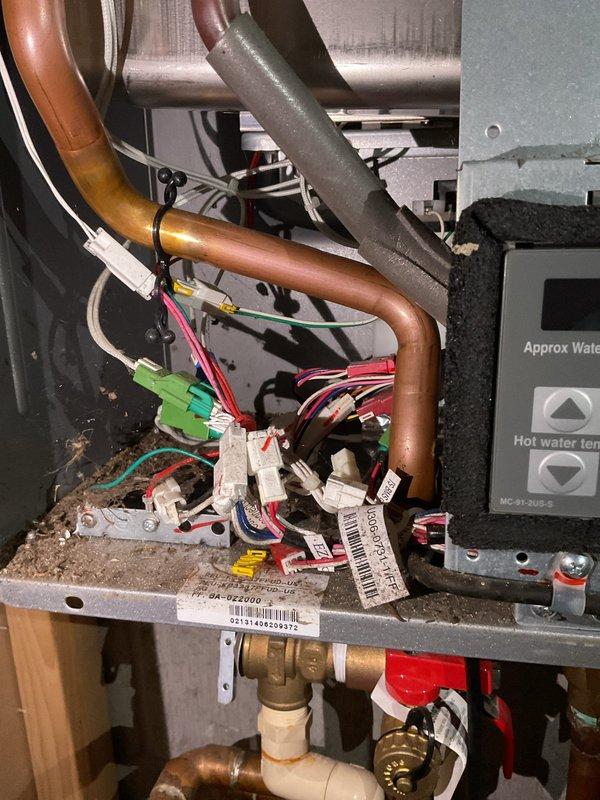 Completed routine maintenance on a Rinnai tankless water heater with no reported issues. Performed comprehensive inspection of all internal components including heat exchanger, gas valve assembly, ignition system, and venting connections. Verified proper operation of control board, temperature settings, and priority button functionality. Inspected all copper supply and return piping, isolation valves with blue handles, and brass fittings for leaks or corrosion. Checked electrical connections, wire harnesses, and grounding throughout the unit. Cleaned burner assembly and verified proper flame characteristics. Flushed heat exchanger to remove mineral buildup and scale deposits. Tested all safety devices including overheat protection and pressure relief systems. Confirmed proper gas pressure and combustion air supply. Verified temperature differential between inlet and outlet water temperatures. Inspected condensate drain system and connections. Unit operating within manufacturer specific