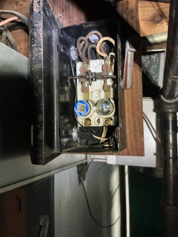 Responded to no-cool condition on 8-year-old Amana air conditioning system. Upon arrival, inspected outdoor condenser unit and traced electrical supply to aging fuse panel in basement. Found blown fuse in obsolete fuse box serving the AC circuit. Replaced failed fuse and verified proper amperage rating. Tested system operation and confirmed condenser and air handler are now functioning normally with adequate cooling restored.