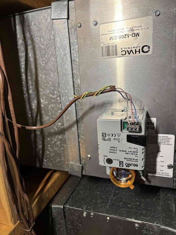 Responded to callback for zone dampers that were replaced previously and developed noise issues again. Inspected HVAC system including air handler unit (model MD-1Z08-EM) and zone damper assembly in attic space serving Zone 2 basement area. Verified humidifier presence and operational status on furnace as requested. Documented system configuration with photos showing damper installation, control wiring, and zone control components mounted on ductwork.