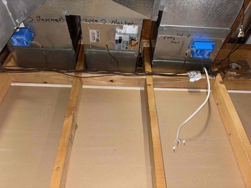 Responded to callback for zone dampers that were replaced previously and developed noise issues again. Inspected HVAC system including air handler unit (model MD-1Z08-EM) and zone damper assembly in attic space serving Zone 2 basement area. Verified humidifier presence and operational status on furnace as requested. Documented system configuration with photos showing damper installation, control wiring, and zone control components mounted on ductwork.
